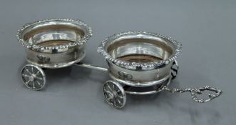 A silver plated double coaster table trolley. 46 cm long.