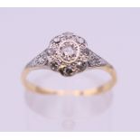 An Edwardian 18 ct gold oval diamond cluster ring. Ring size M. 2.3 grammes total weight.