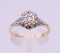An Edwardian 18 ct gold oval diamond cluster ring. Ring size M. 2.3 grammes total weight.