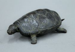 A patinated bronze model of a tortoise. 14 cm long.