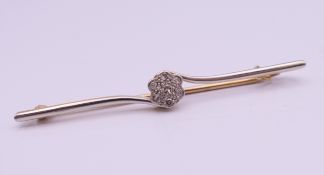 A 15 ct gold and diamond bar brooch. 5.5 cm wide. 3.2 grammes total weight.