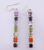 A pair of silver seven stone drop earrings. 4 cm high.