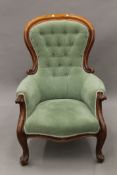 A Victorian button upholstered spoon back armchair. 68 cm wide.