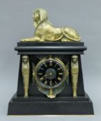 A 19th century black marble mantle clock decorated in the Egyptian revival manner.
