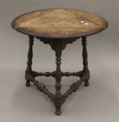 A Victorian carved oak triple drop leaf table. 59 cm wide.