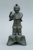 An 18th/19th century Chinese bronze model of an attendant. 18.5 cm high.