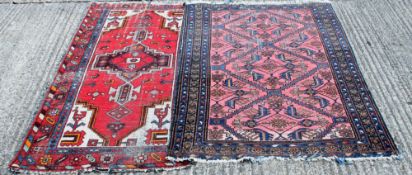 Two red ground Persian rugs. 107 x 184 cm and 125 x 180 cm.