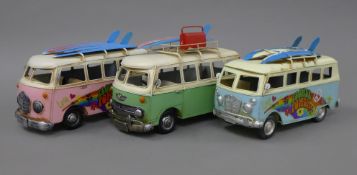 Three tin plate camper vans. The smallest 24 cm long.