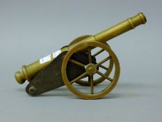 A 19th century brass and iron model table cannon. 26.5 cm long.