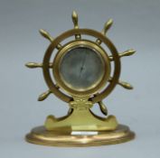 A Victorian brass desk top barometer formed as a ships wheel. 18.5 cm high.