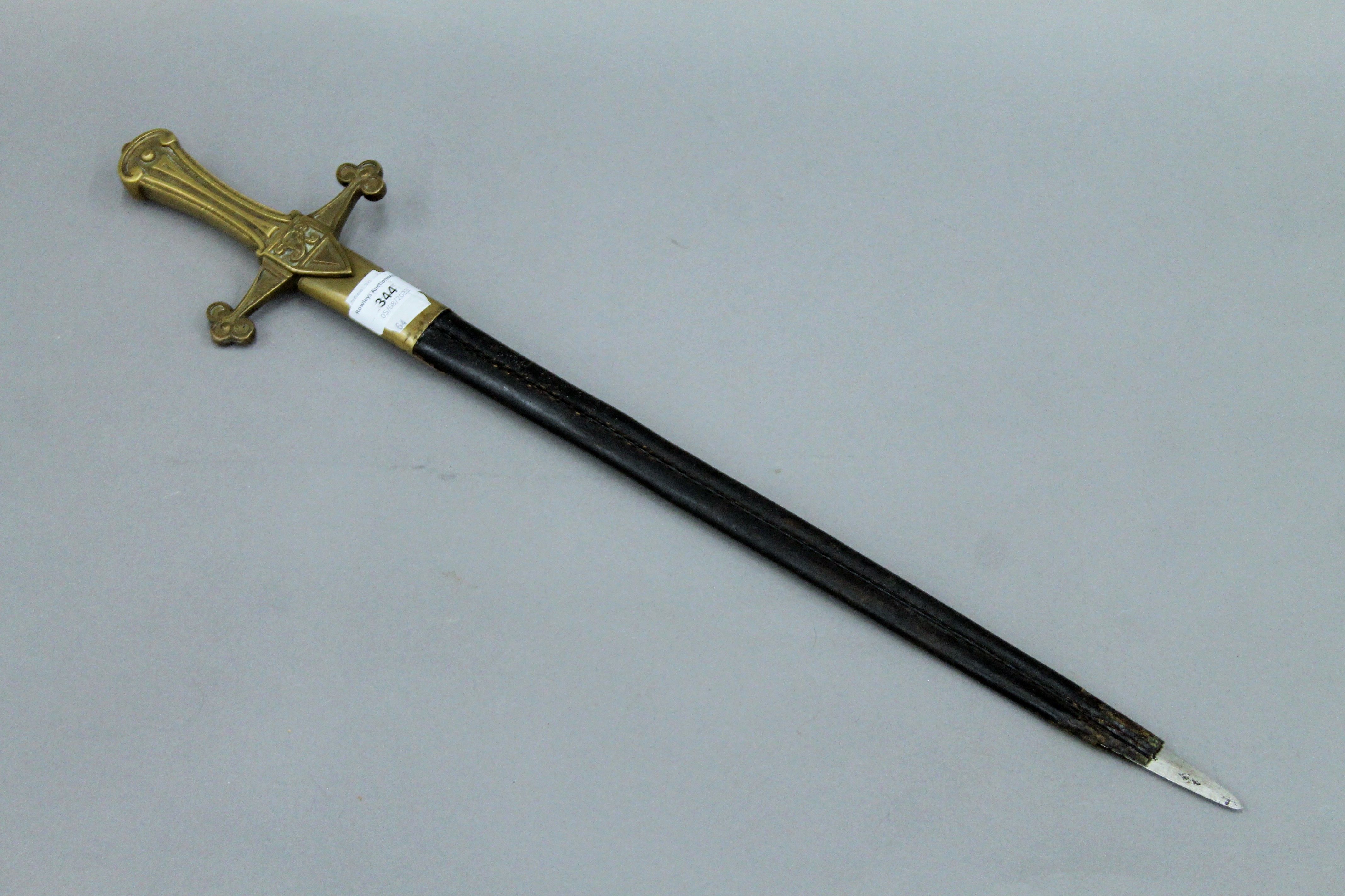 A Victorian short sword in scabbard. 64.5 cm long.