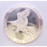 A 1 ounce fine silver peregrine falcon coin.