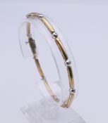 A 9 ct gold and white gold diamond bracelet. 19 cm long. 7.1 grammes total weight.