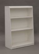 Two small white painted bookcases. The largest 61 cm wide.