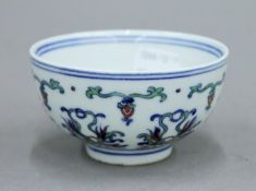 A Chinese porcelain tea bowl with blue painted six character mark to base. 9 cm diameter.