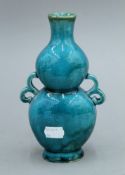 A 19th century Chinese turquoise ground pottery double gourd vase. 19.5 cm high.