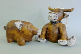 Two leather doorstops - one formed as a pig and the other a cow. The former 36 cm long.