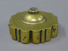 An 18th century Indian brass spice box. 11 cm diameter.