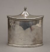 An oval silver tea caddy. 10 cm wide. 171.5 grammes.