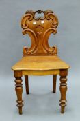 A Victorian oak hall chair. 47.5 cm wide.