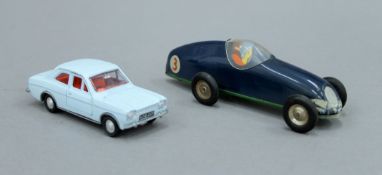 A Minic clockwork racing car, boxed and a Dinky Ford Escort 168, boxed.