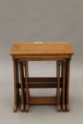 A nest of three teak tables, with attached Lister Wood Craft label,