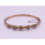 An unmarked gold seed pearl set bangle form bracelet. 6.5 cm wide. 7.3 grammes total weight.