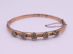 An unmarked gold seed pearl set bangle form bracelet. 6.5 cm wide. 7.3 grammes total weight.