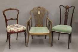 An Edwardian inlaid mahogany open armchair, another inlaid chair and a balloon back chair.