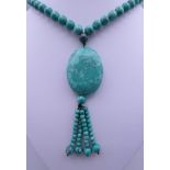 A turquoise pendant necklace. Necklace 88 cm long, pendant 10 cm high.