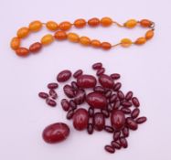 An amber bead necklace (approximately 38 cm long) and a quantity of cherry amber beads.