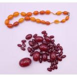 An amber bead necklace (approximately 38 cm long) and a quantity of cherry amber beads.