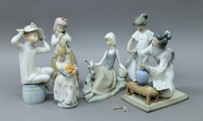 A quantity of Lladro and Nao porcelain figurines.