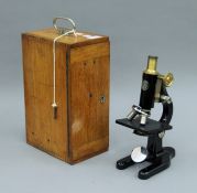 A C Baker London monocular microscope in mahogany case, with extra eye pieces. The case 35 cm high.