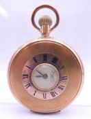 A gold plated half hunter pocket watch. 5 cm diameter.