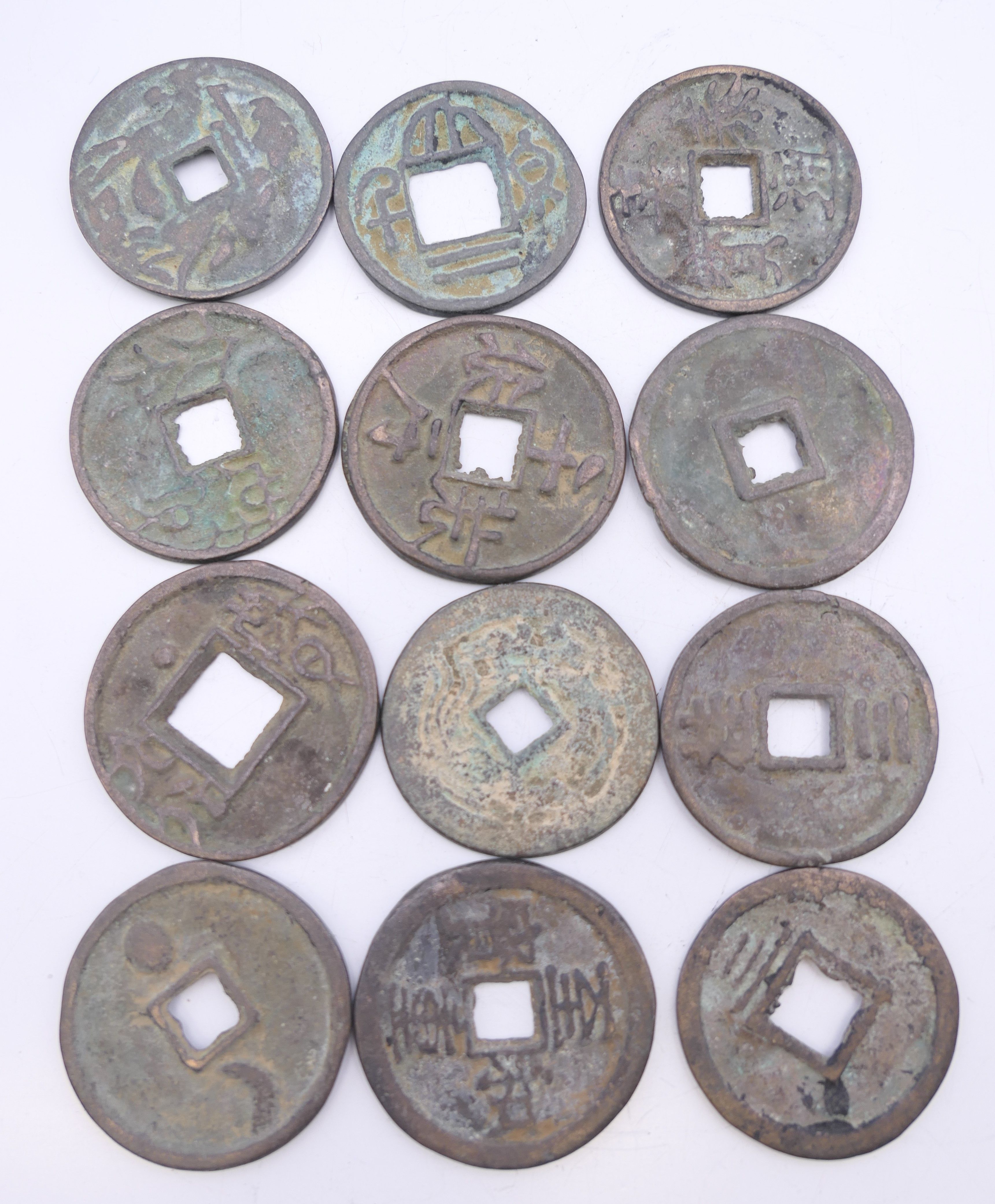 A quantity of Chinese coins. Approximately between 3 cm - 3.5 cm diameter.