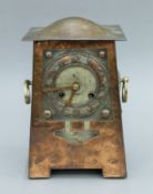 An Arts and Crafts beaten copper mantle clock, in the manner of the Glasgow School. 31 cm high.