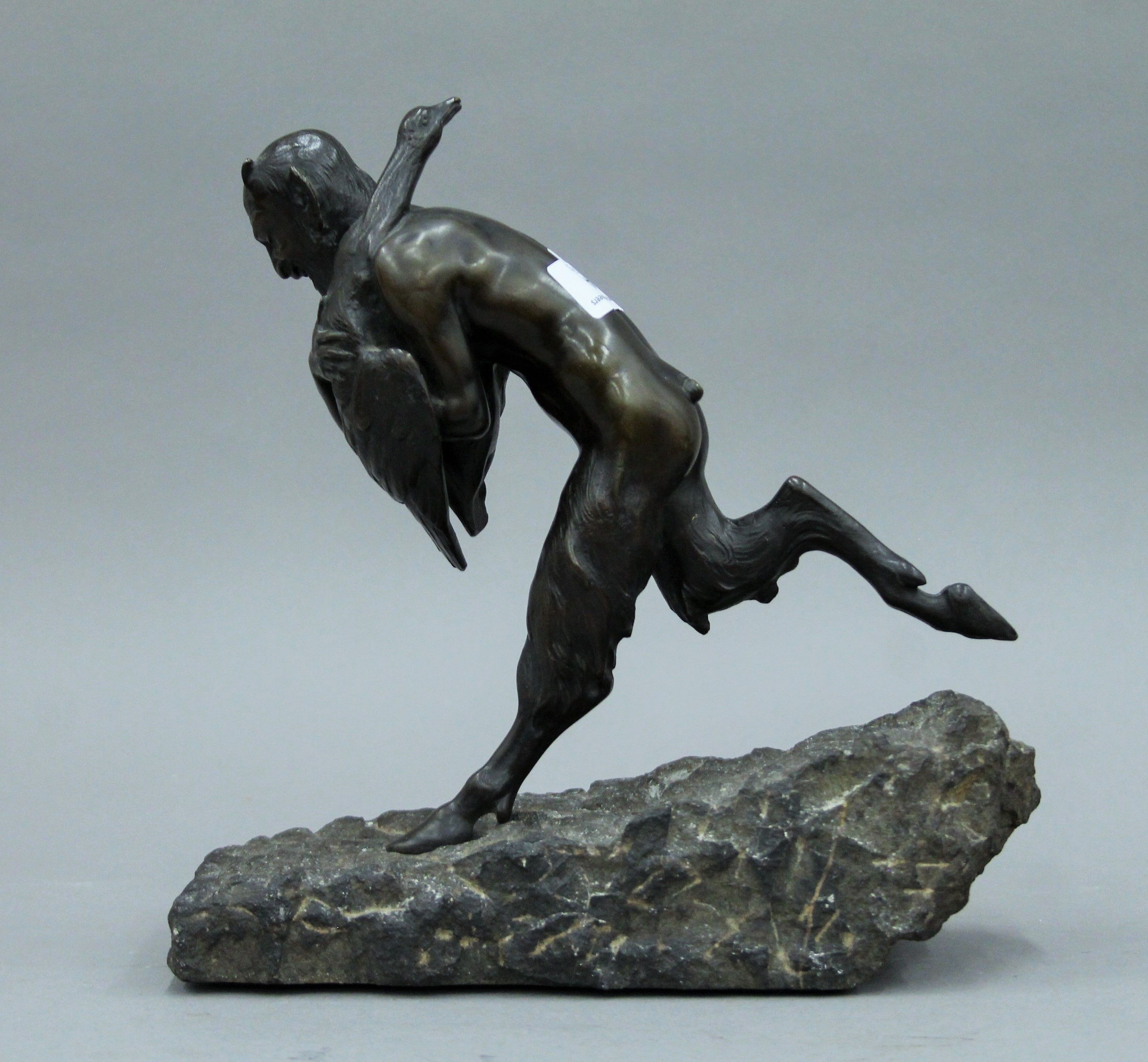 A patinated bronze model a faun and a goose mounted on a carved stone base. 26 cm high. - Image 4 of 4