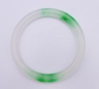 A two tone jade bangle. 5.5 cm interior diameter.