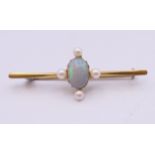 A 15 ct gold opal and seed pearl bar brooch. 4.5 cm long. 3.2 grammes total weight.