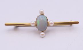 A 15 ct gold opal and seed pearl bar brooch. 4.5 cm long. 3.2 grammes total weight.