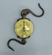 A 19th century brass and iron hanging balance. 13 cm diameter.
