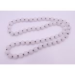 A white jade bead necklace. 70 cm long.