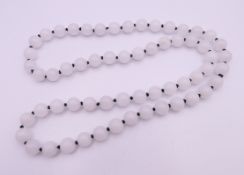 A white jade bead necklace. 70 cm long.