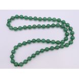 A jade bead necklace. 68 cm long.