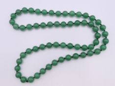 A jade bead necklace. 68 cm long.