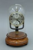 An 800 day clock under glass dome. 25 cm high.