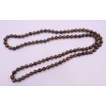 A tigerseye bead necklace. 92 cm long.