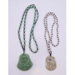 Two jade pendant and necklaces. The largest pendant 5 cm high.