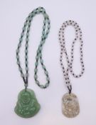 Two jade pendant and necklaces. The largest pendant 5 cm high.